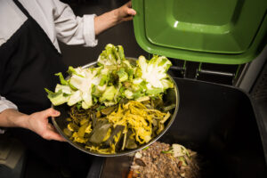 Kitchen staff disposing of food waste