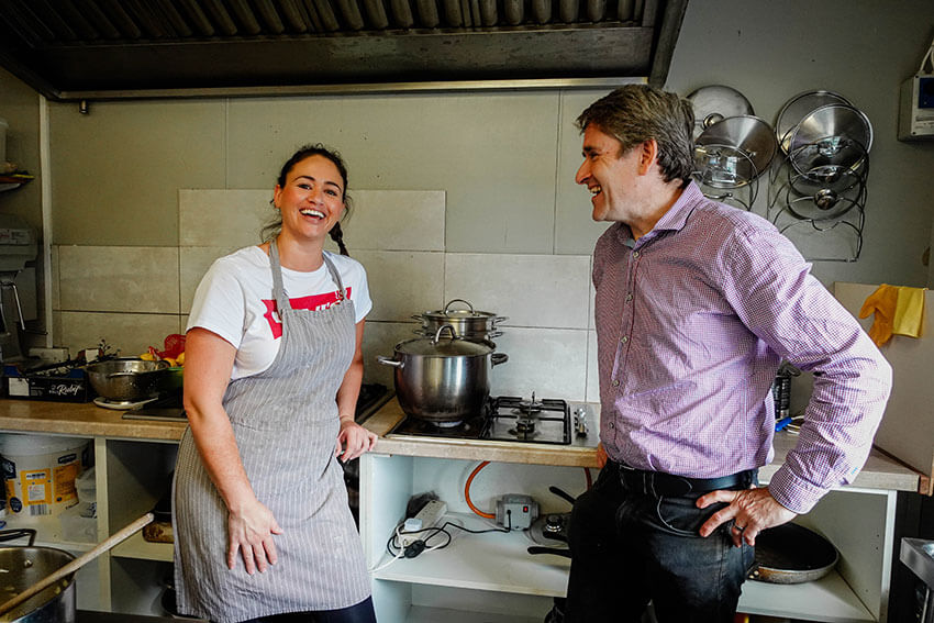 Rachel Scott and MyGug founder Kieran Coffee in Rebecca's Kitchen where ham for sandwiches is cooking on MyGug biogas.